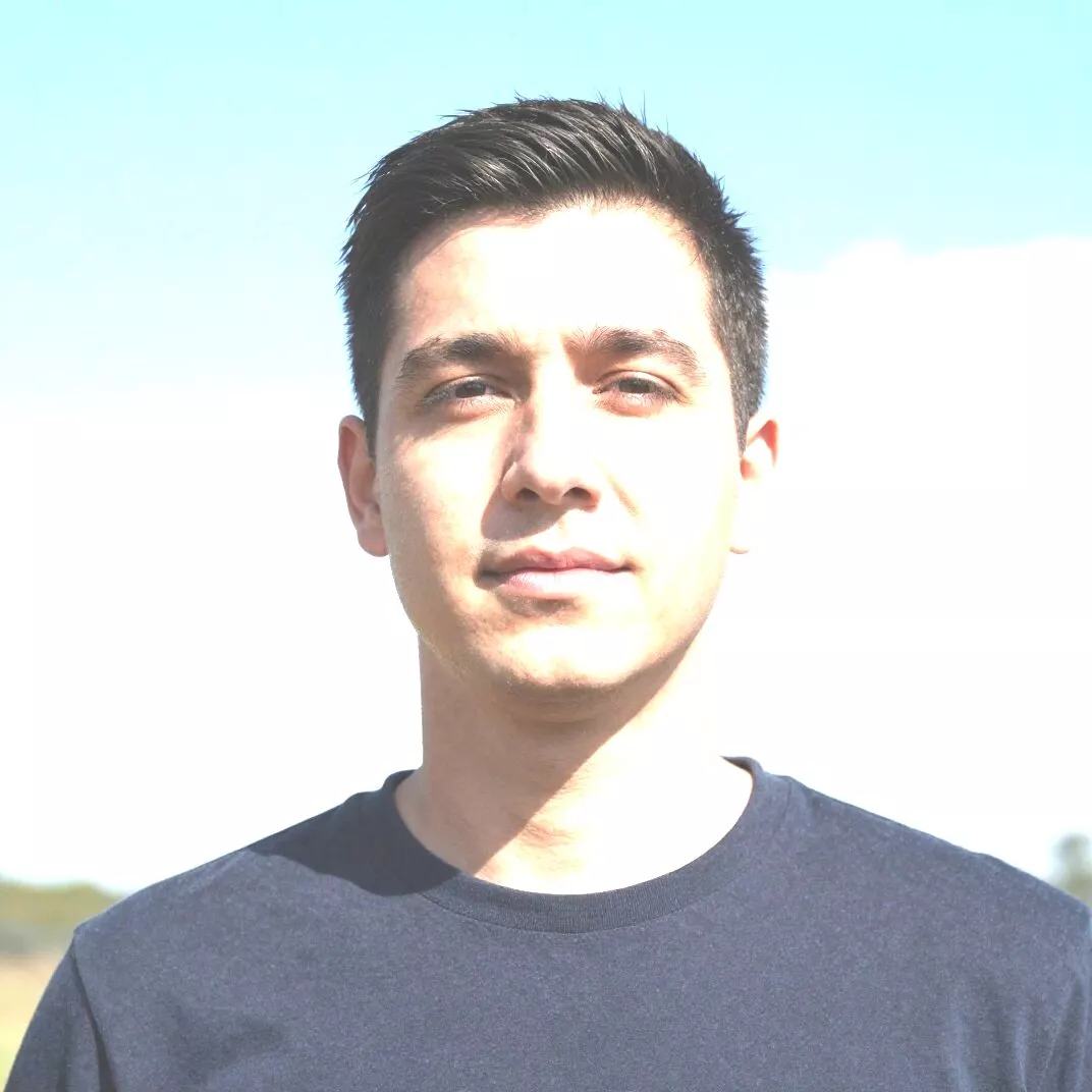 Overexposed beach portrait with a blown-out white sky and washed-out pale faces before AI highlight recovery