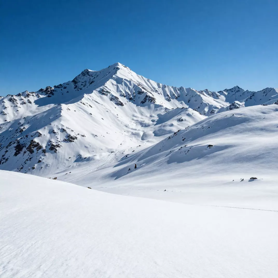 Same snowy mountain landscape after AI tone-mapping with recovered snow texture and natural blue sky